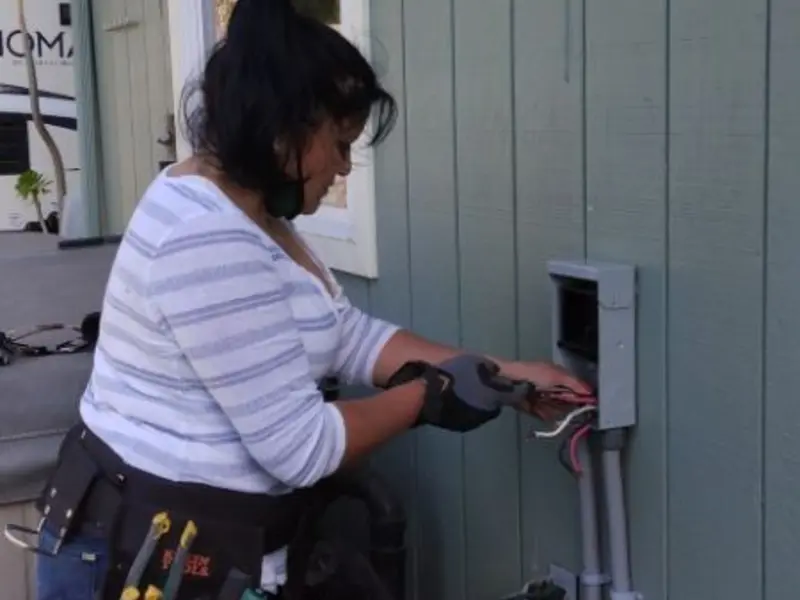 Licensed electrician wiring an exterior subpanel in Van Buren